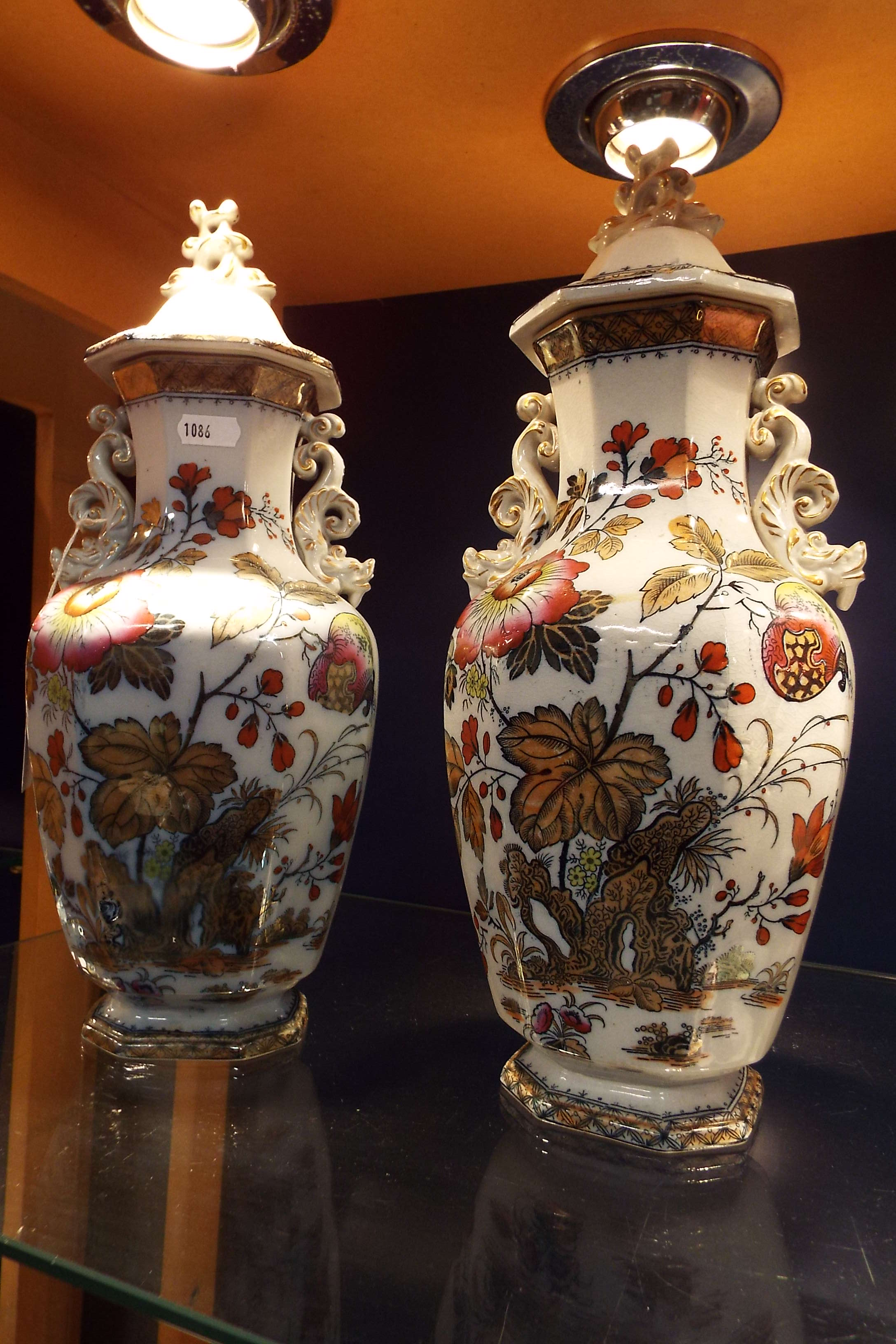 A pair of 19thC Chinese style lidded vases Damage to top right and hairline crack