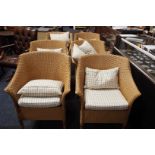 A set of six Lloyd Loom tub shaped armchairs with cushion seats