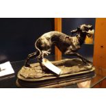 A 19thC bronze sculpture of a whippet holding a riding crop,