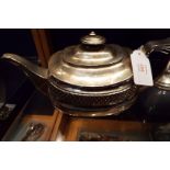 A George III silver teapot of squat form embossed with hobnail banding with scrolled handle and