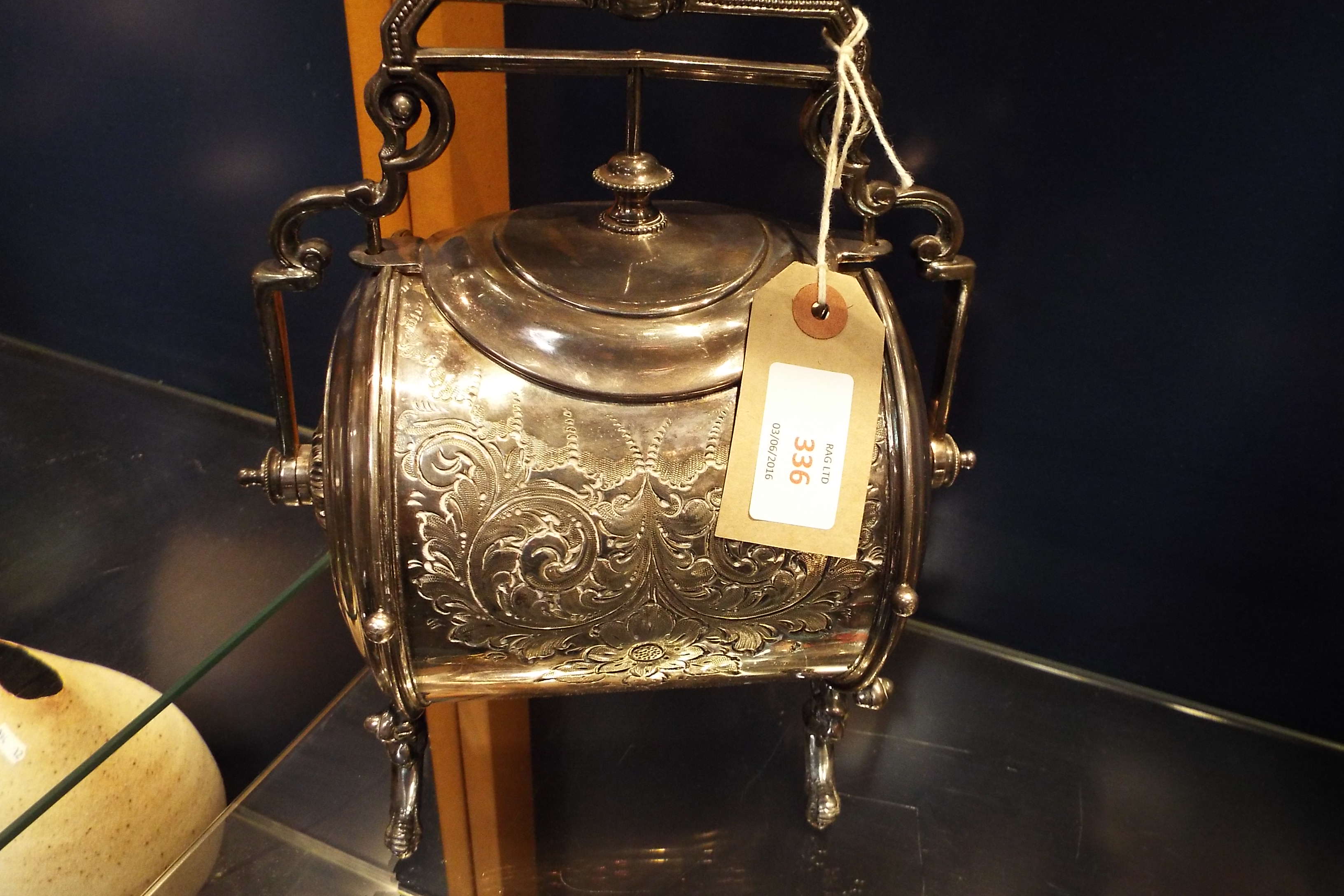 A Victorian silver-plated biscuit barrel heavily engraved with foliate scrolls and flower heads,