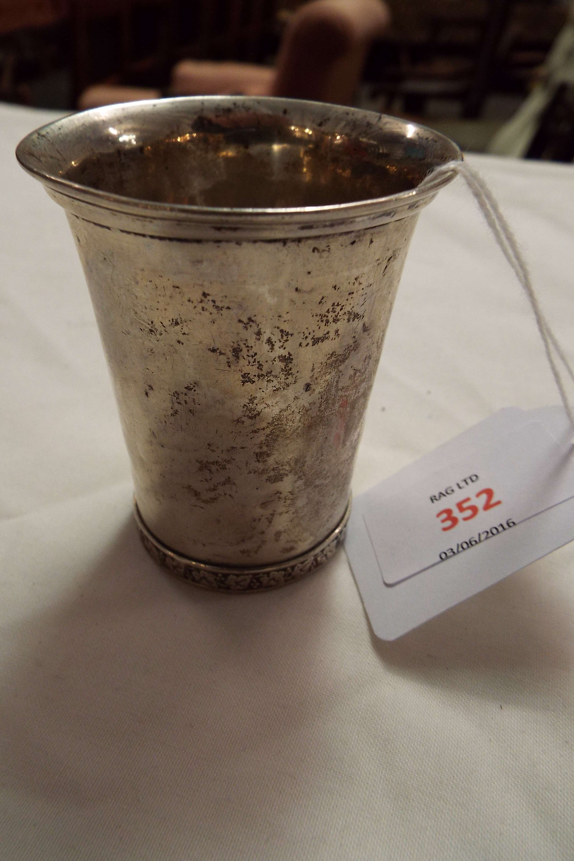 An early 20thC Dutch 833 standard silver beaker the base with band of grapes and vines