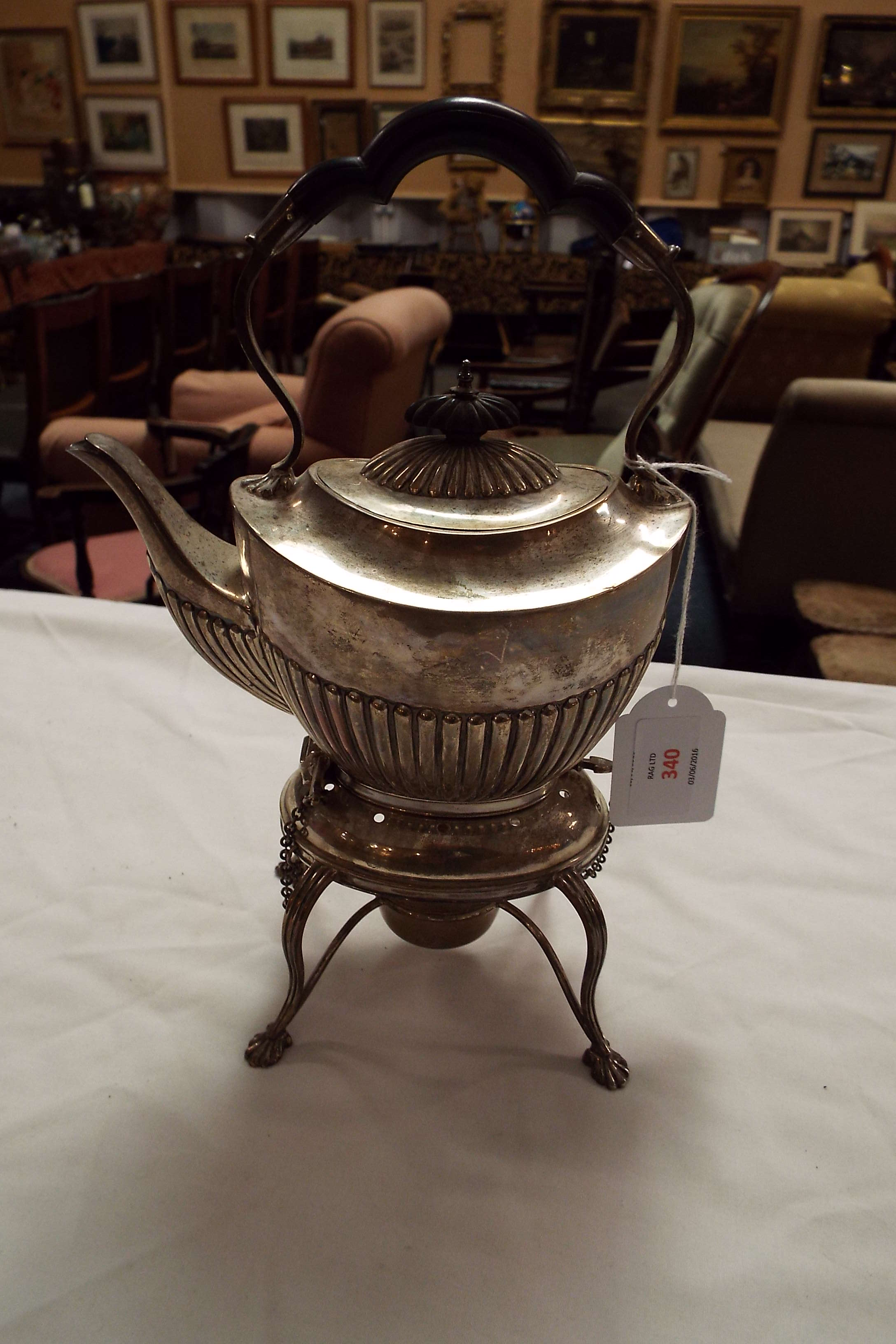 A Queen Anne 1904 Sheffield silver kettle resting on a stand