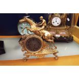 A gilt ormolu desk clock with a leaping horse and rider