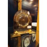 A 1920's amber mirror glass dome shaped mantel clock