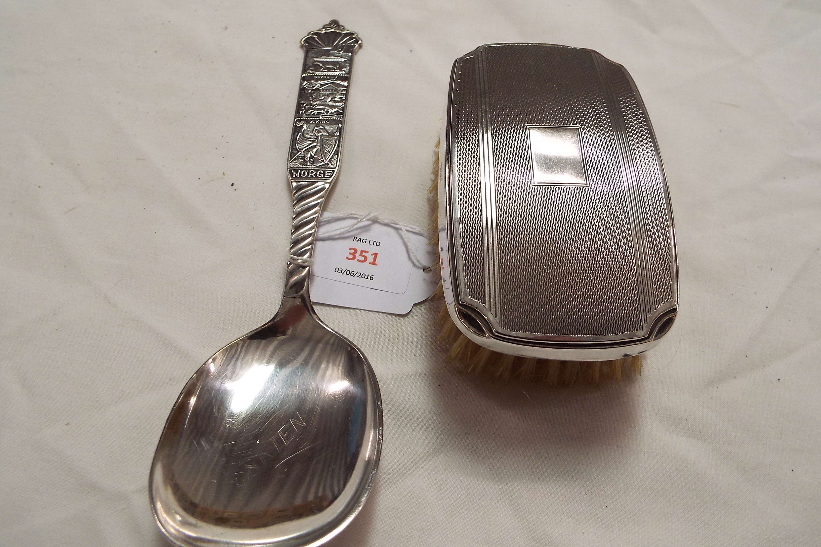 A silver backed brush together with a silver plated Danish spoon