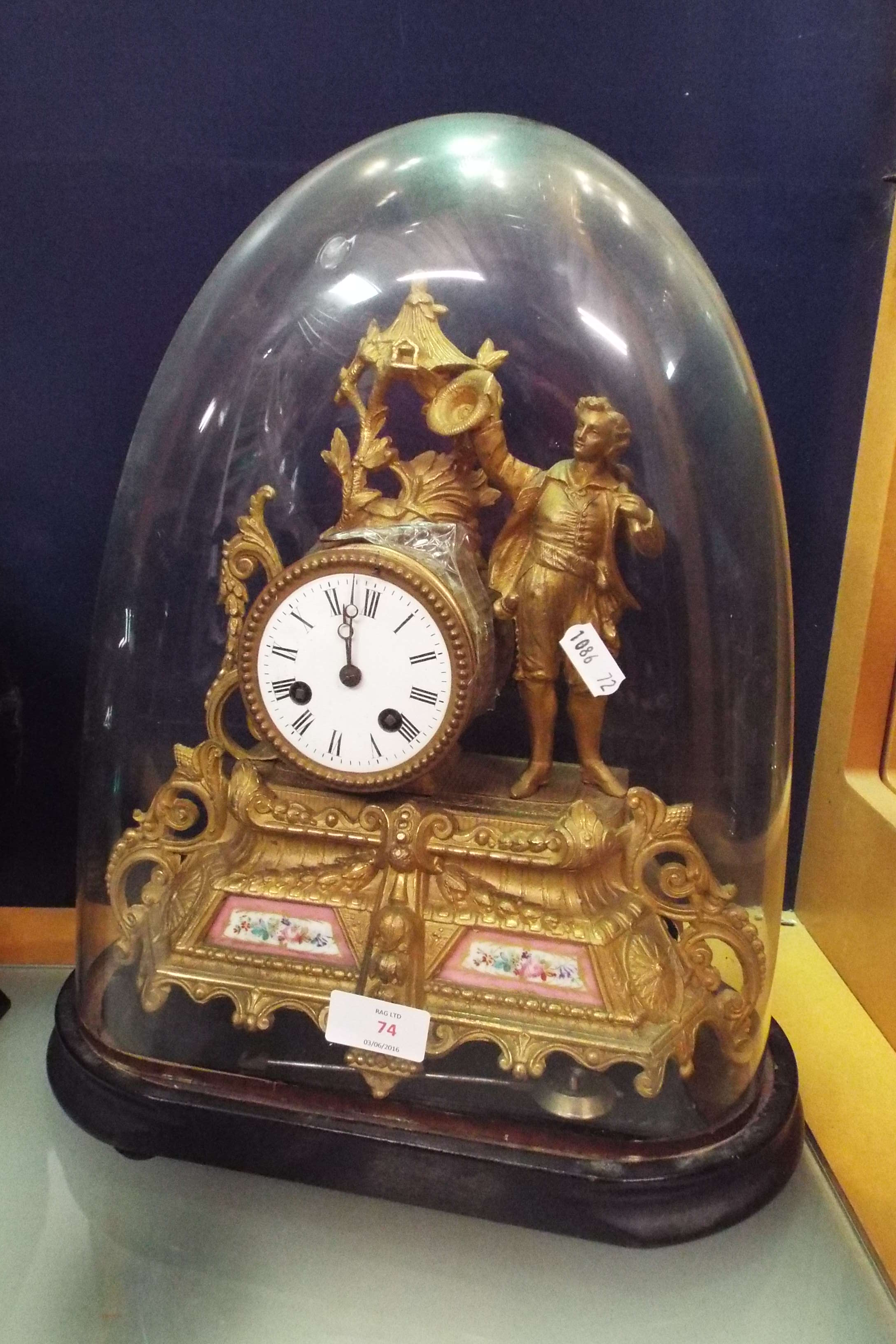 A Regency style French gilt figural clock surmounted with a young male,