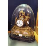 A Regency style French gilt figural clock surmounted with a young male,