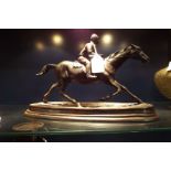 A bronze sculpture of a horse and jockey,