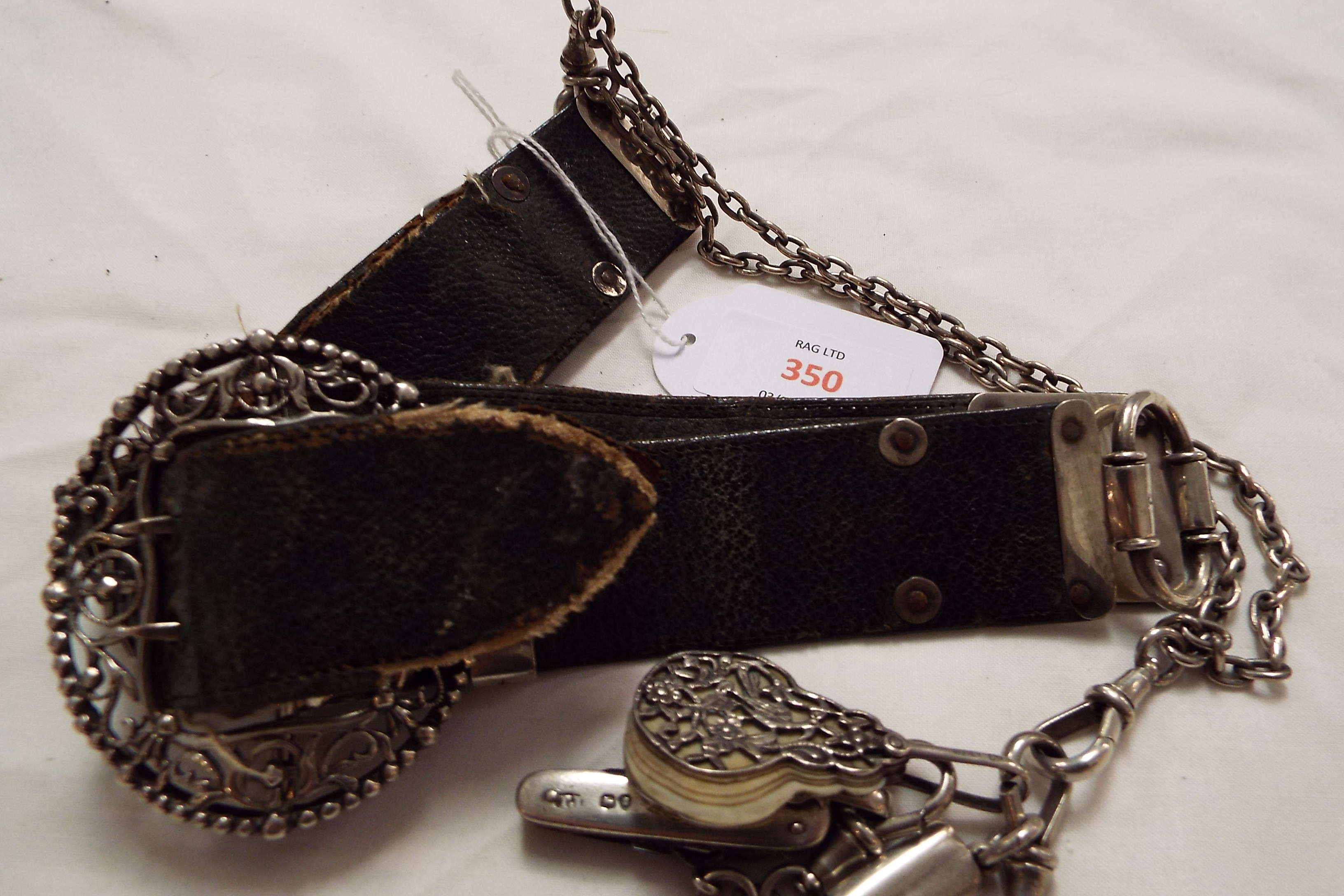 A Victorian leather and silver belt with pierced foliate buckle,