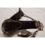 A Victorian leather and silver belt with pierced foliate buckle,