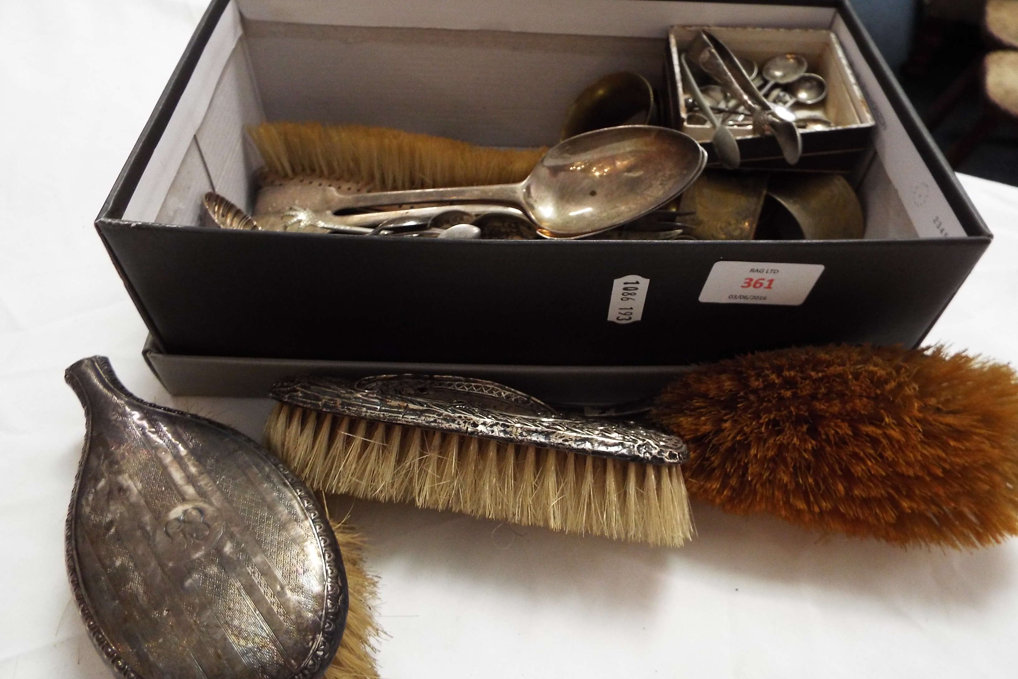 A mixed selection of silver and silver-plated ware to include spoons, brushes,