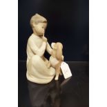 A Lladro figurine of a boy with dog in matt finish
