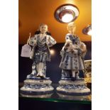A pair of continental blue and white figures, boy and girl,