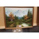 A late 20thC oil on canvas landscape view of a river with mountains beyond,