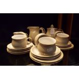 A six place Denby Linen tea set comprising cups and saucers, tea plates, covered sugar bowl,