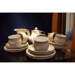 A six place Denby Linen tea set comprising cups and saucers, tea plates, covered sugar bowl,