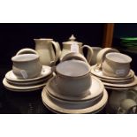 A six place Denby Linen tea set comprising cups and saucers, tea plates, covered sugar bowl,