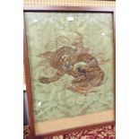 A large Oriental embroidery on damask fabric of a dragon,