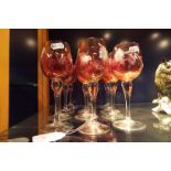A set of twelve cranberry glasses with engraved floral decoration