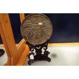 A Japanese bronze mirror on carved hardwood stand with crane and prunus decoration