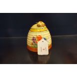 A Clarice Cliff large 'Beehive' form honey pot in the 'Crocus' pattern,