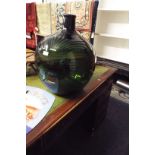 A modern large green glass carboy