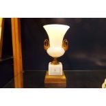 An opaque glass urn with gilt metal ornate handles resting on acanthus gilt base (A/F to rim)