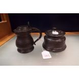 An antique pewter inkwell and a lidded tankard