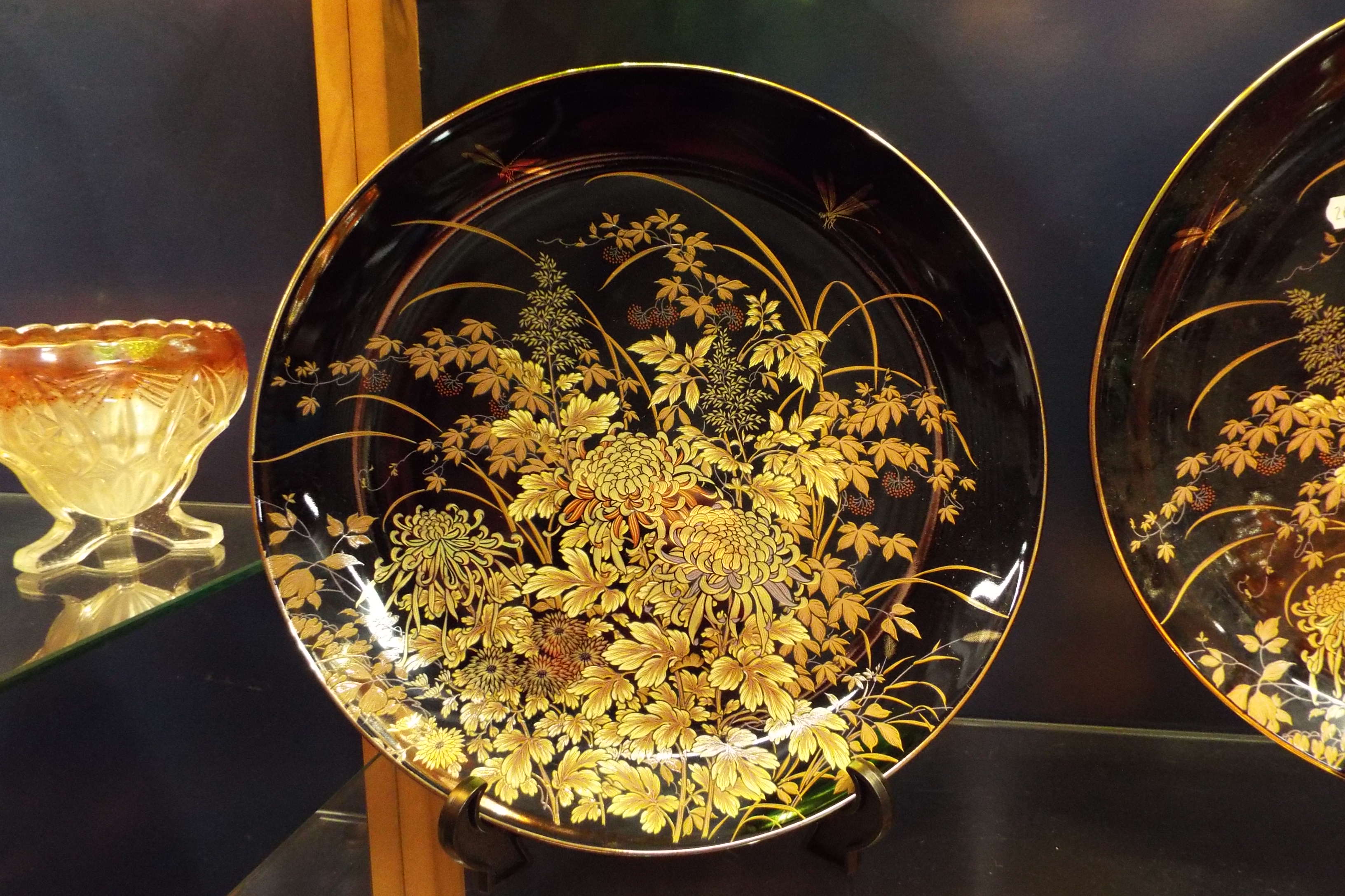 Three Japanese black glazed cabinet plates with floral decoration