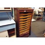 A nine drawer filing cabinet with tambour shutter