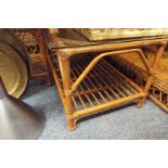 A bamboo and wicker glass topped coffee table with under tier as new