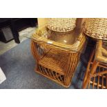 A bamboo and wicker glass topped coffee table with under tier as new