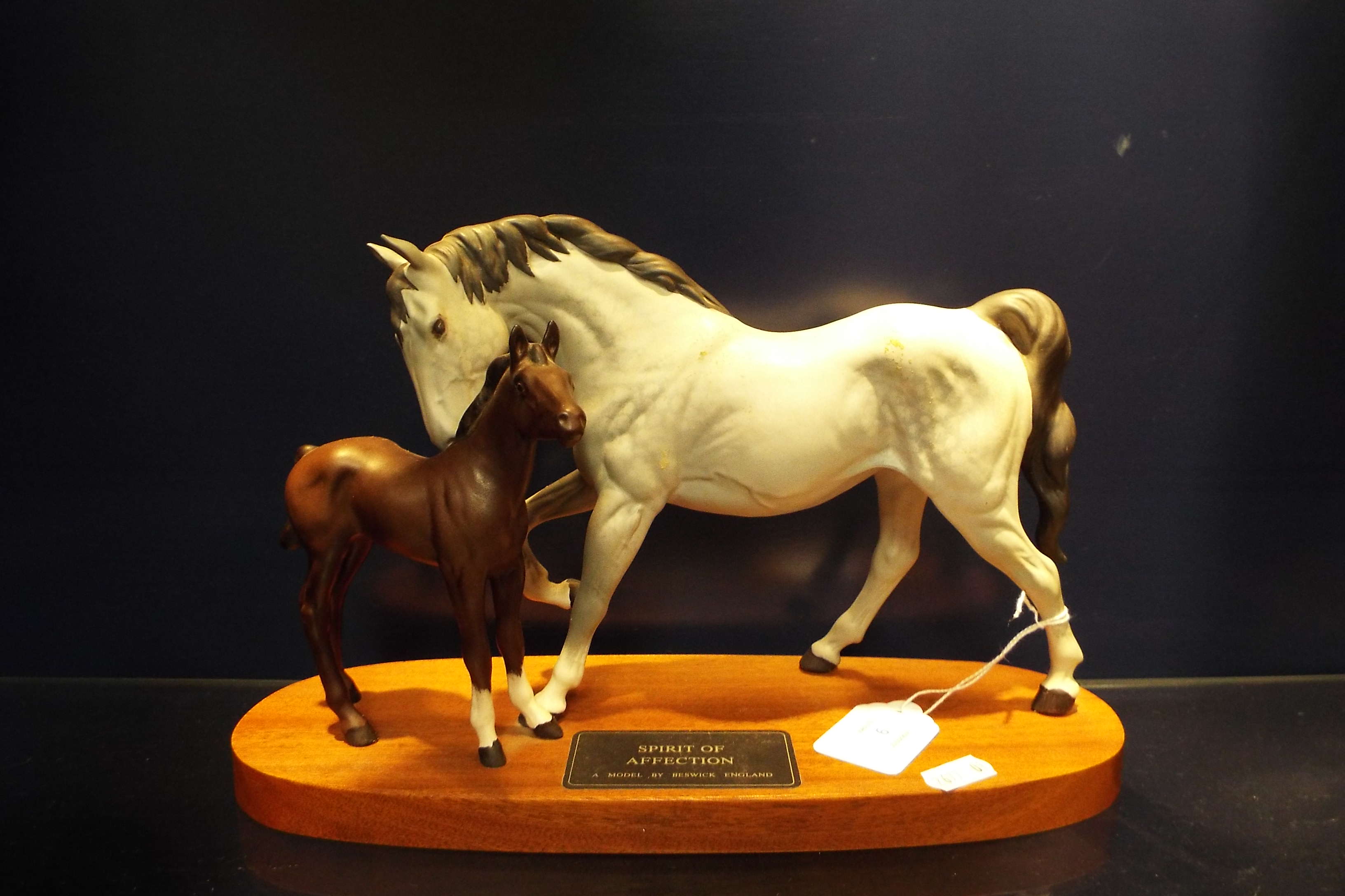 A Beswick figurine 'Spirit of Affection' on a wooden plaque