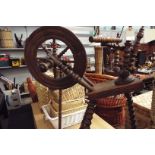 An antique oak bobbin turned spinning wheel slight damage