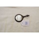 A miniature silver-plated hand mirror