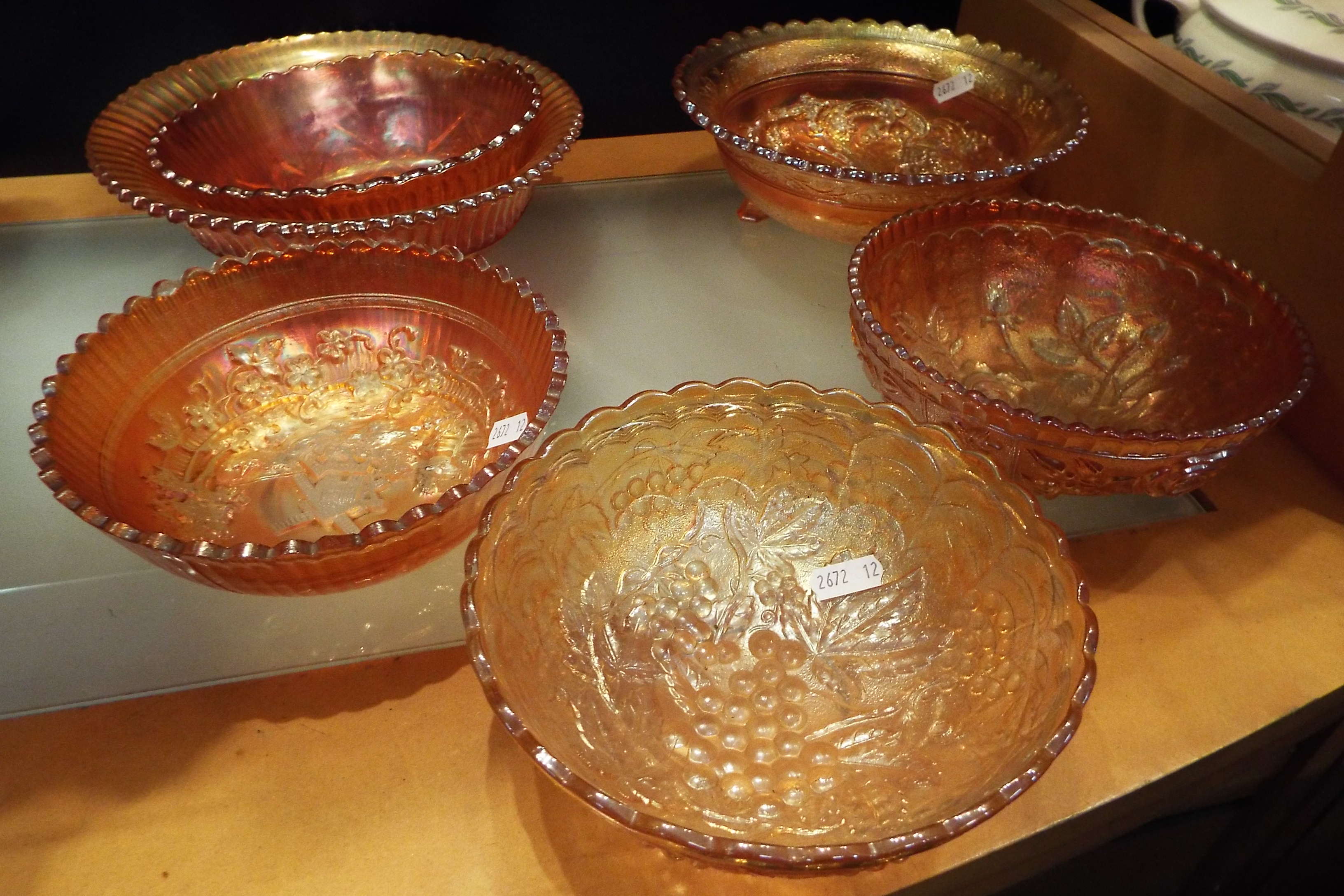 A group of six carnival glass bowls with assorted decoration