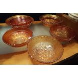 A group of six carnival glass bowls with assorted decoration