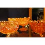 A group of five carnival glass bowls with floral and starburst decoration