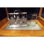 A silver plated tantalus complete with decanters and plated bottle labels for 'Whiskey', 'Brandy',