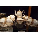 A Queen Anne bone china tea set with gilt decoration