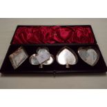 A boxed set of Sheffield 1898 silver pin dishes in the form of playing cards suits