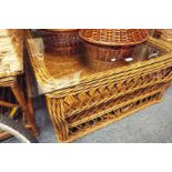 A large bamboo and wicker glass topped coffee table with under tier as new