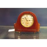 A mahogany arched top Zenith mantle clock having Arabic numerals and secondary dial resting on