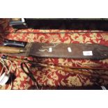 A military machete and leather scabbard