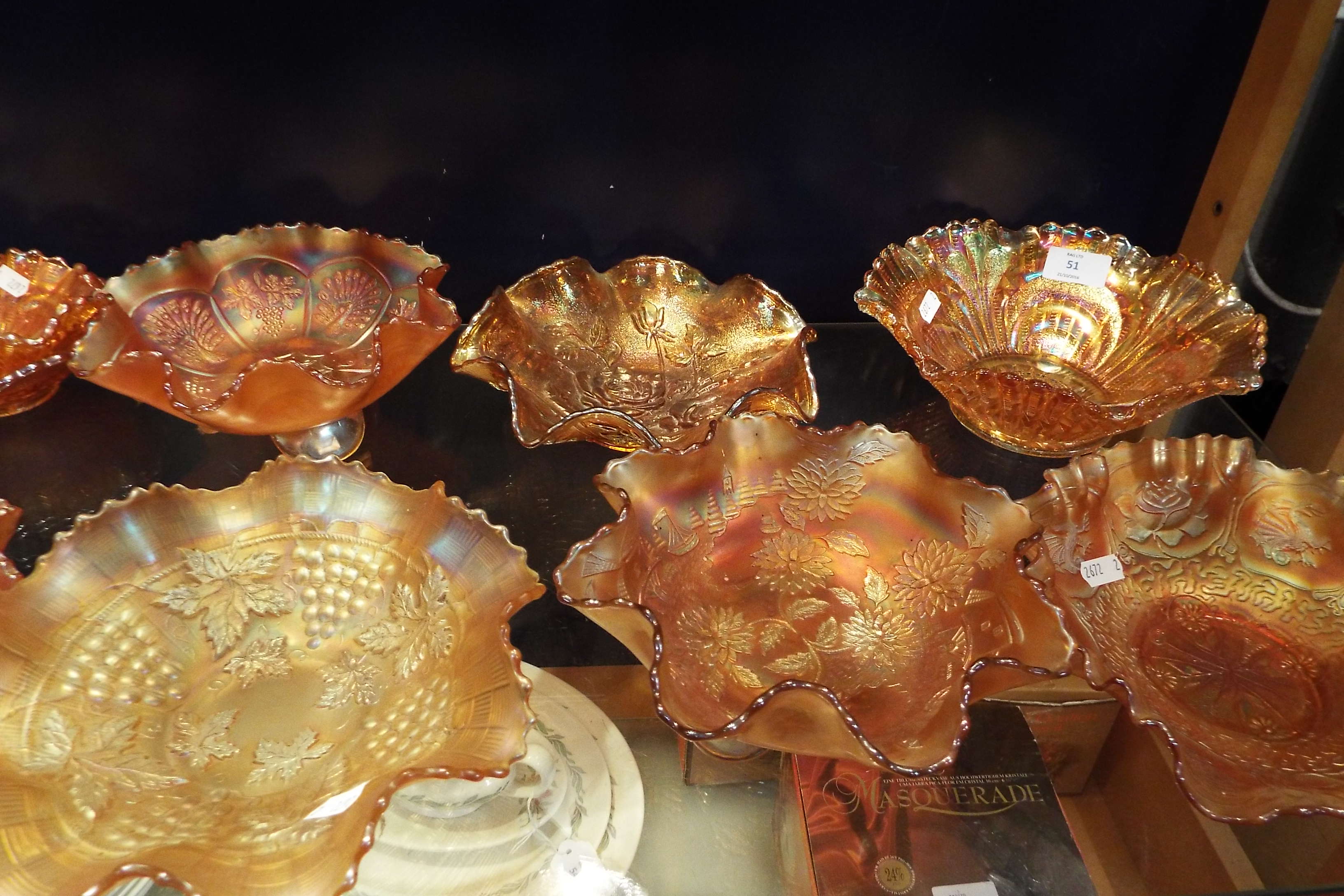 A group of six carnival glass pinch top bowls with floral bird and dragon decoration