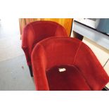 A pair of red velvet upholstered pub tub chairs