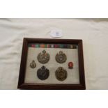 A framed group of Royal Engineers cap badges,