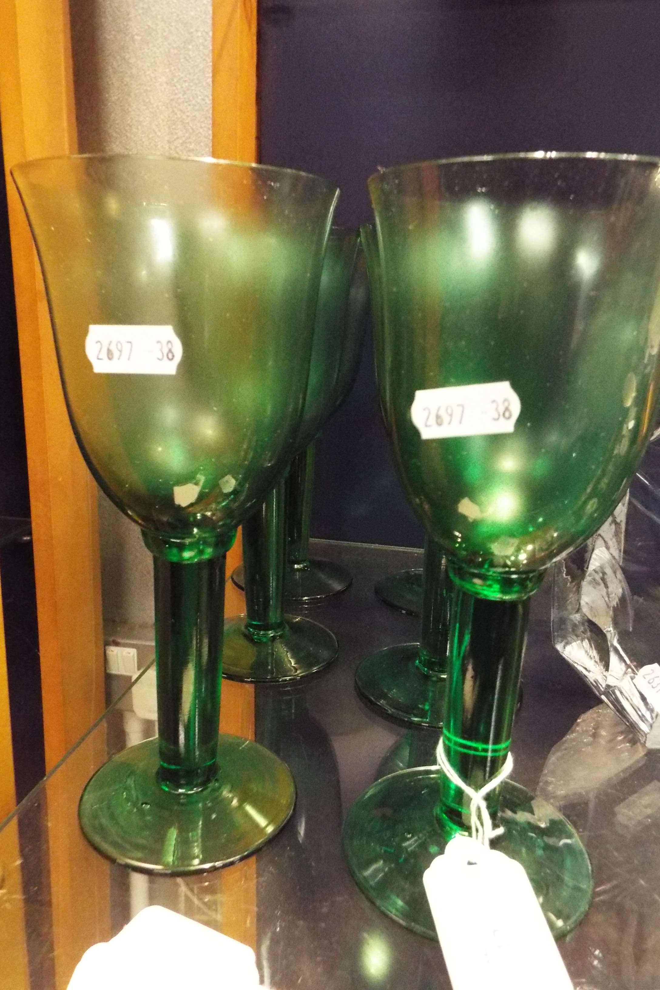 A set of six green glass wine goblets