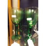 A set of six green glass wine goblets